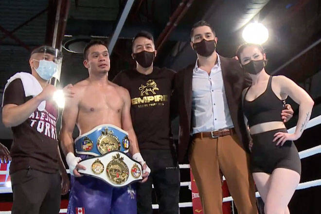 Alex Torres shows off the championship belts he won after defeating Jose Luis Zarate Lara in a Canadian Professional Boxing Council title unification match. (Empire Promotions pay-per-view)