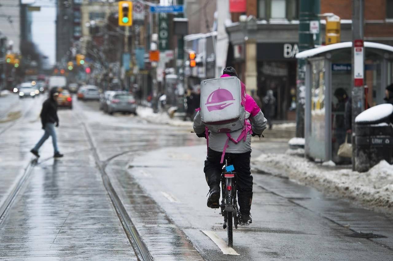 A Foodora courier is pictured as they pick up an order for delivery from a restaurant in Toronto, Thursday, Feb. 27, 2020. THE CANADIAN PRESS/Nathan Denette
