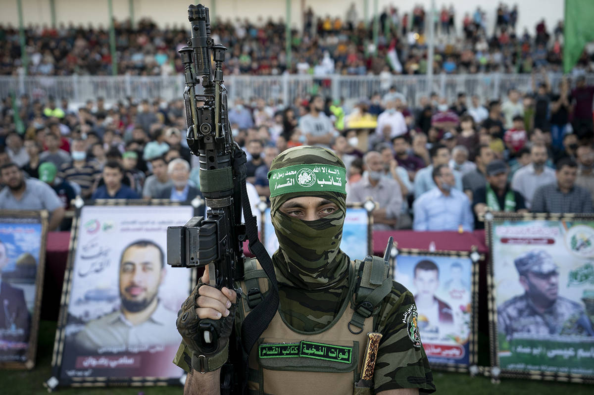 Militants stand guard around the stage as Yahya Sinwar, the Palestinian leader of Hamas in the Gaza Strip, makes a rally appearance days after a cease-fire was reached following an 11-day war between Gaza’s Hamas rulers and Israel, Monday, May 24, 2021, in Gaza City, the Gaza Strip. (AP Photo/John Minchillo)