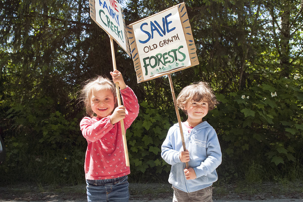 Ayana Benning, 5, and her brother Tulsie Benning, 4, marched up with their signs and parents to join the celebration at Braden Main forest service road, where the police exclusion line was breached May 29. (Zoe Ducklow/News Staff)