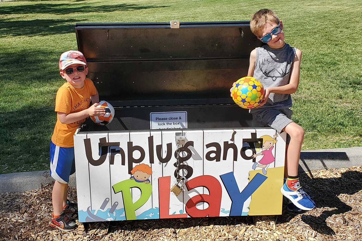 Declan Powell, four, left, and big brother Ethan, six, check out the freshly stocked Unplug and Play Box at Vernon’s Lakeview Park courtesy of the North Okanagan Optimist Club, which has been given permission to operate the boxes again after being closed all of 2020 due to COVID. (Roger Knox - Morning Star)