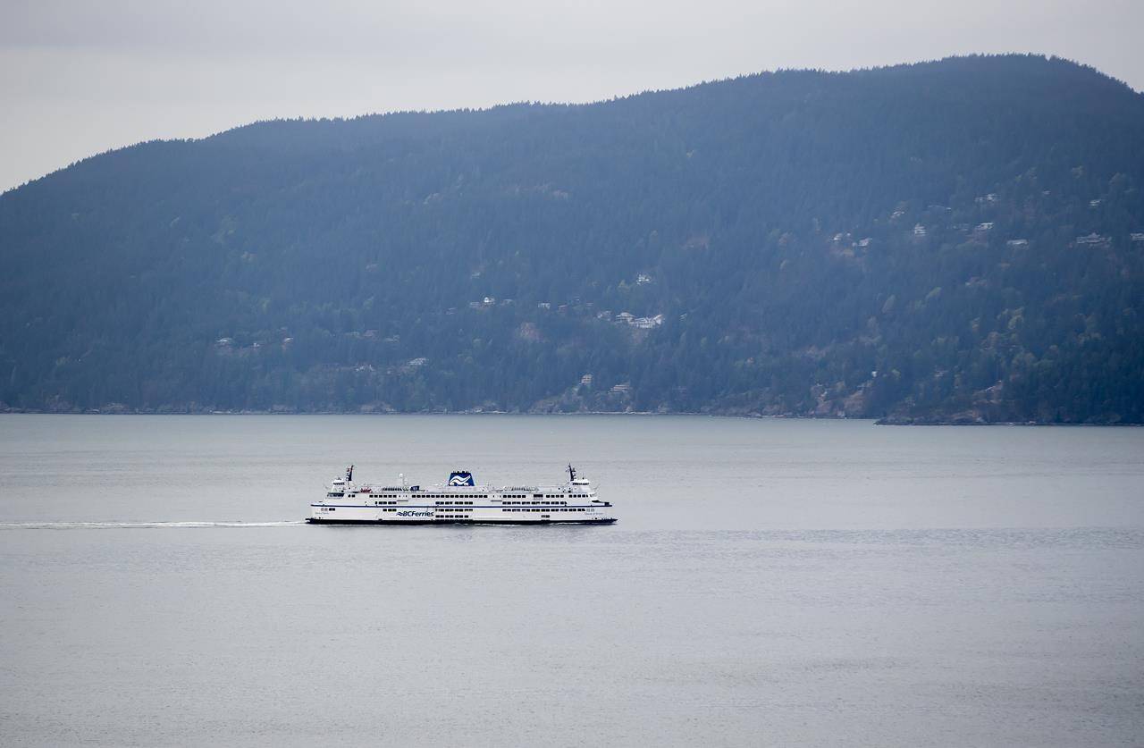 FILE – A B.C. Ferries vessel passes Bowen Island while traveling on Howe Sound from Horseshoe Bay to Langdale, B.C., on Friday, April 23, 2021. A BC Ferries passenger was recovered from the waters near Bowen Island after going overboard Sunday, after another passenger witnessed them fall off the ferry mid-afternoon. THE CANADIAN PRESS/Darryl Dyck