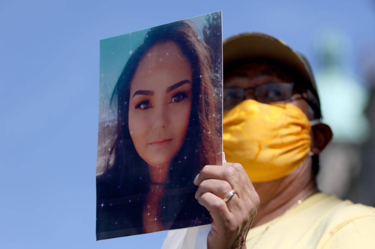 A man holds a picture of Chantel Moore during a healing gathering at the B.C. Legislature in Victoria on June 18, 2020. THE CANADIAN PRESS/Chad Hipolito