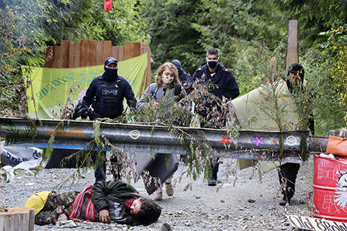 Police monitor protesters at a blockade in the Fairy Creek area of southwestern Vancouver Island on Wednesday, June 9. (Facebook photo)
