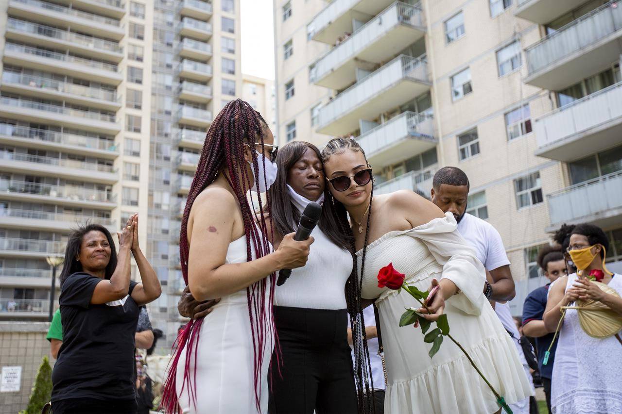 Regis Korchinski-Paquet’s mother, Claudette Beals, is comforted after singing at a public memorial and walk for justice held to honour the woman who fell to her death from a balcony while police were in her apartment in Toronto, Saturday, July 25, 2020. Several Black and Indigenous families whose loved ones have been harmed and killed by police came together in Ottawa to mark Juneteenth and demand accountability and changes to the justice system. THE CANADIAN PRESS/Carlos Osorio