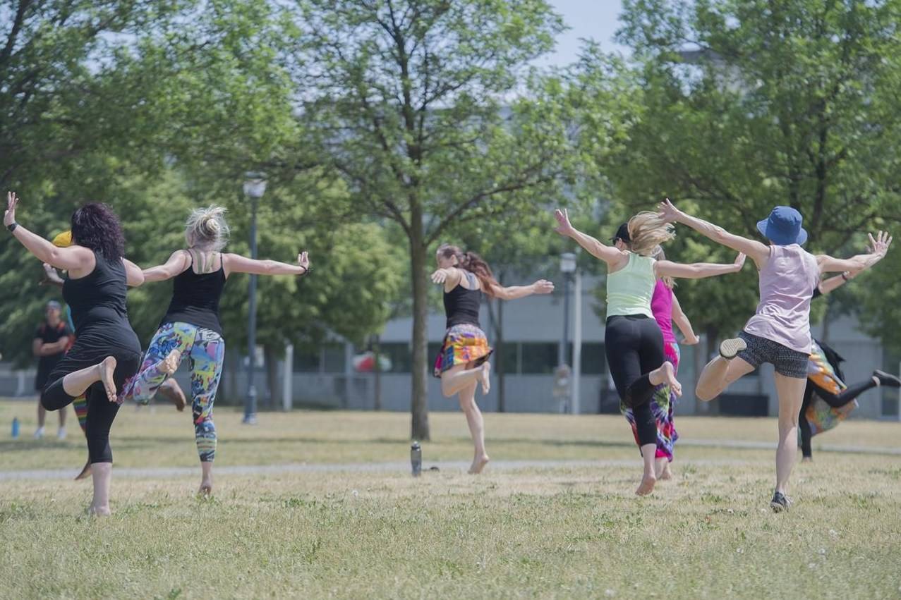 People stay physically distanced as they take part in a outdoor dance class in a park in Montreal on June 13, 2021. THE CANADIAN PRESS/Graham Hughes