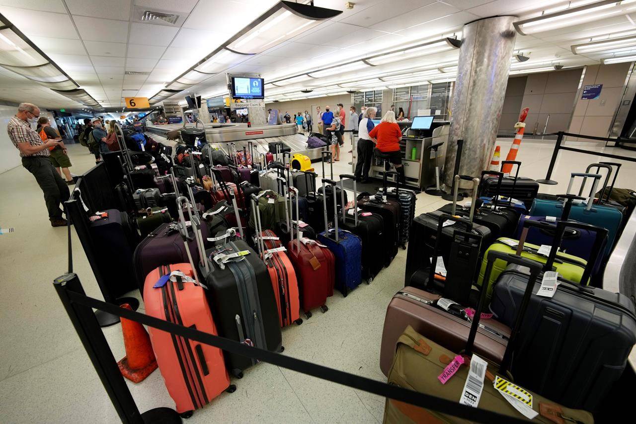 Baggage stacks up from delayed travellers in the baggage claim area in Denver International Airport Wednesday, June 16, 2021, in Denver. THE CANADIAN PRESS/AP/David Zalubowski