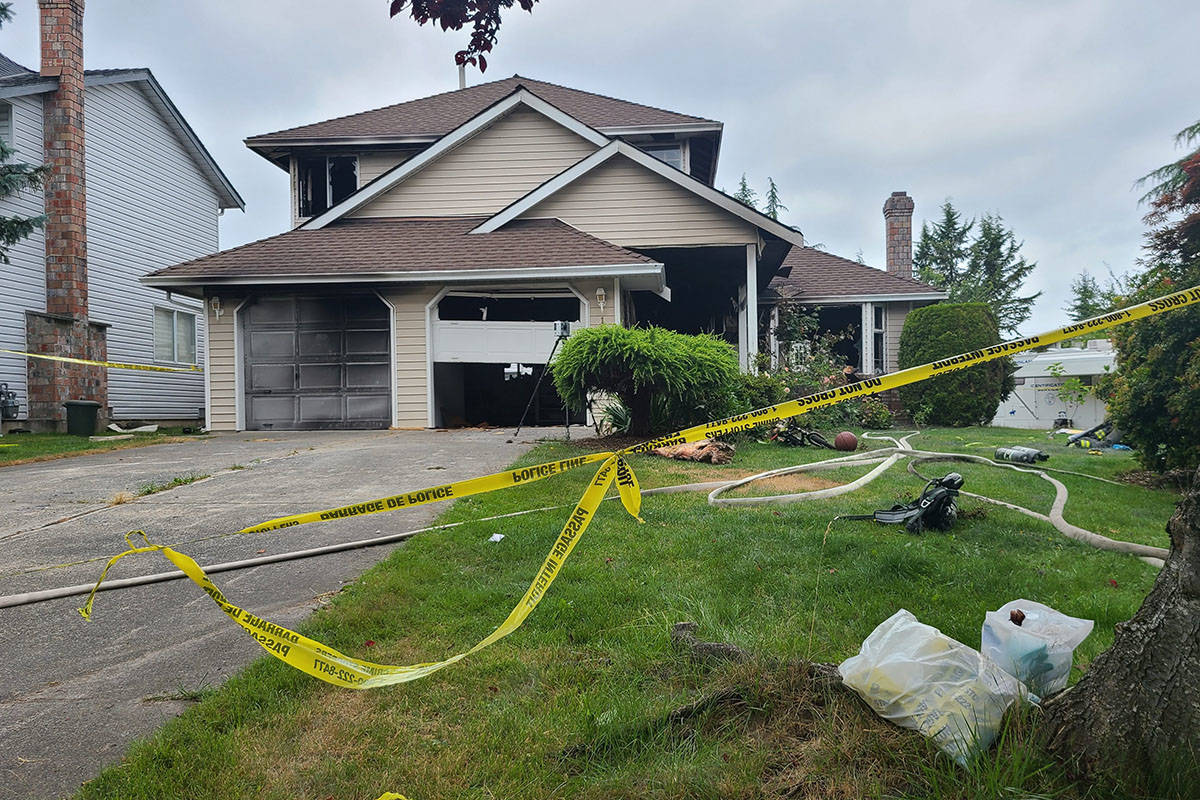A Surrey home sits behind police tape after the body of a five-year-old child was found in the burned out home. (Aaron Hinks photo)