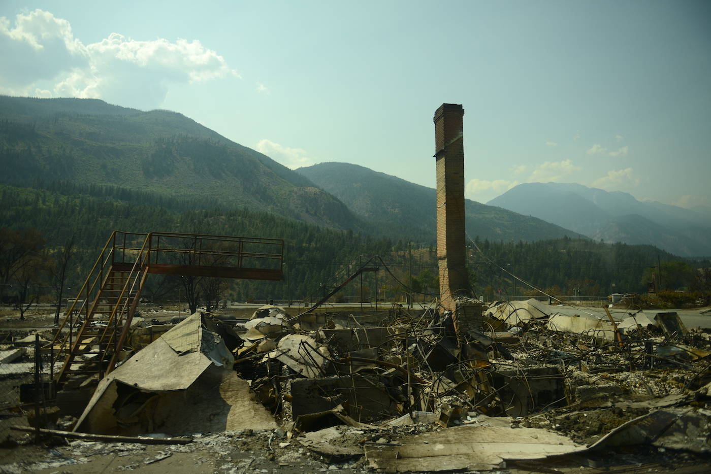 A chimney stands amid debris in Lytton, B.C. on Friday, July 9, 2021, nine days after a wildfire ripped through the village on June 30, 2021. (Jenna Hauck/ Black Press Media)
