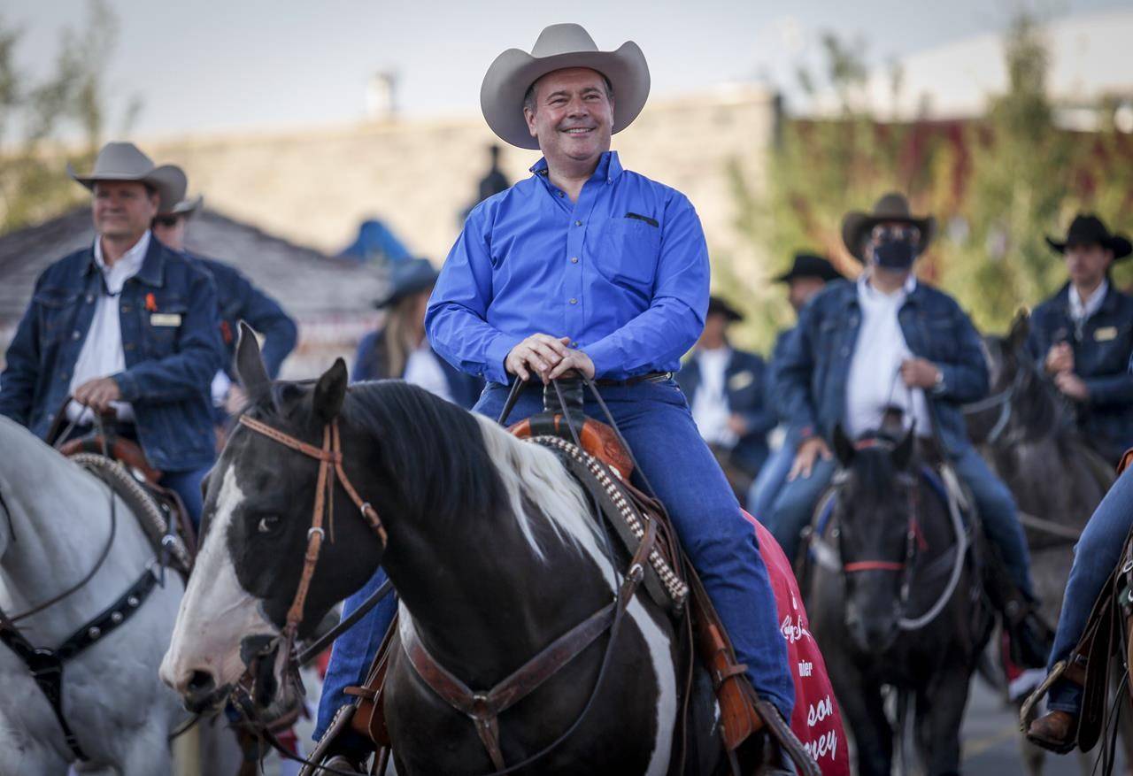 Alberta Premier Jason Kenney rides in the Calgary Stampede parade in Calgary, Alta., Friday, July 9, 2021. THE CANADIAN PRESS/Jeff McIntosh
