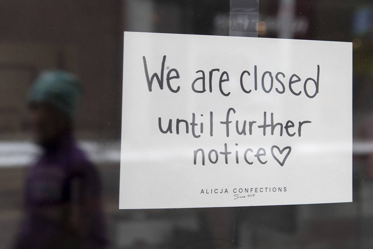 FILE – A sign on a shop window indicates the store is closed in Ottawa, Monday March 23, 2020. THE CANADIAN PRESS/Adrian Wyld