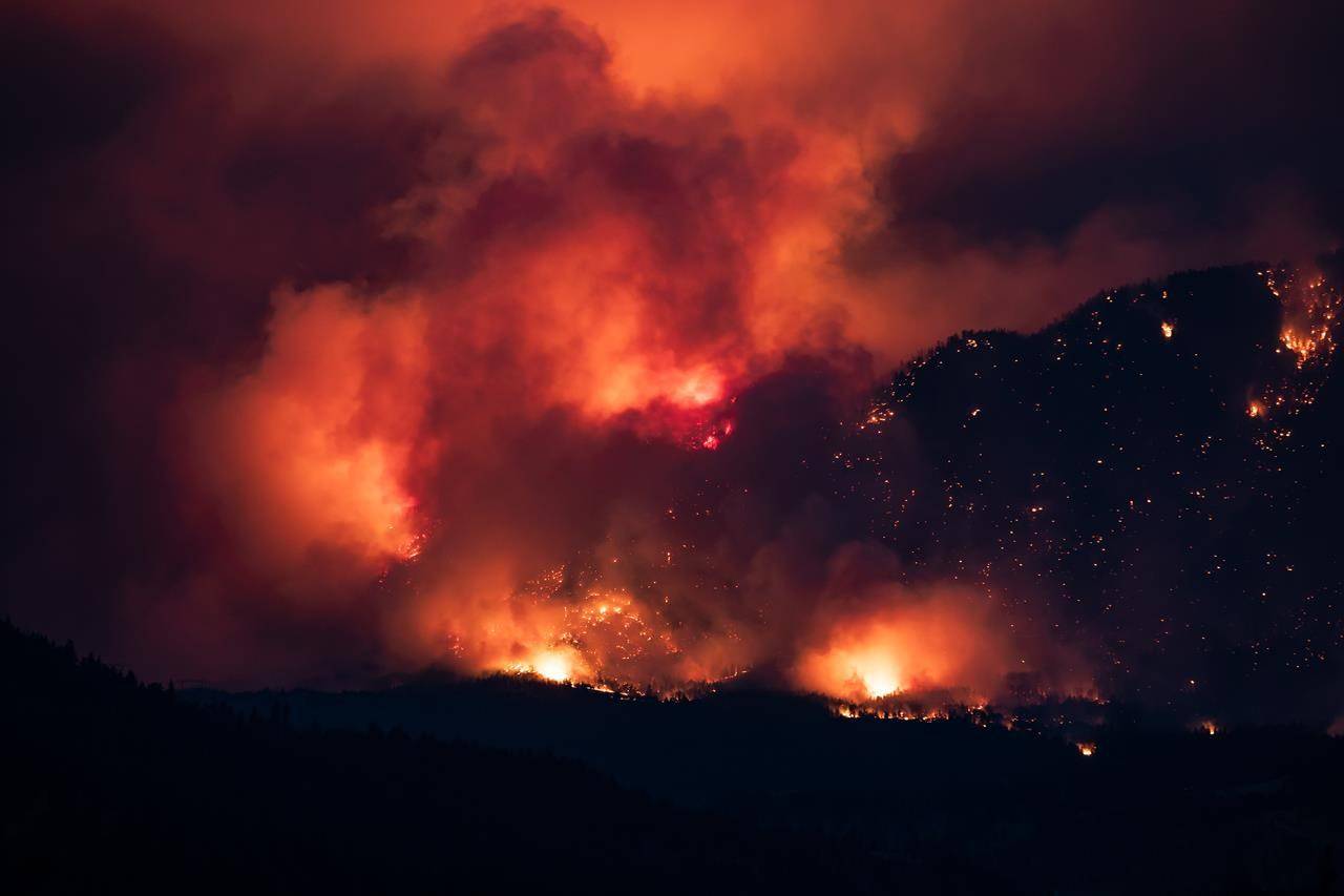 A wildfire burns on the side of a mountain in Lytton, B.C., Thursday, July 1, 2021. THE CANADIAN PRESS/Darryl Dyck