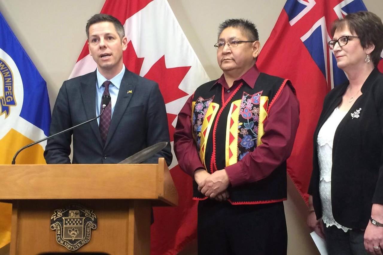 Winnipeg Mayor Brian Bowman, Shoal Lake 40 First Nation Chief Erwin Redsky and Manitoba Indigenous Affairs Minister Eileen Clarke speak to reporters at Winnipeg city hall on Monday Dec. 12, 2016. THE CANADIAN PRESS/Steve Lambert