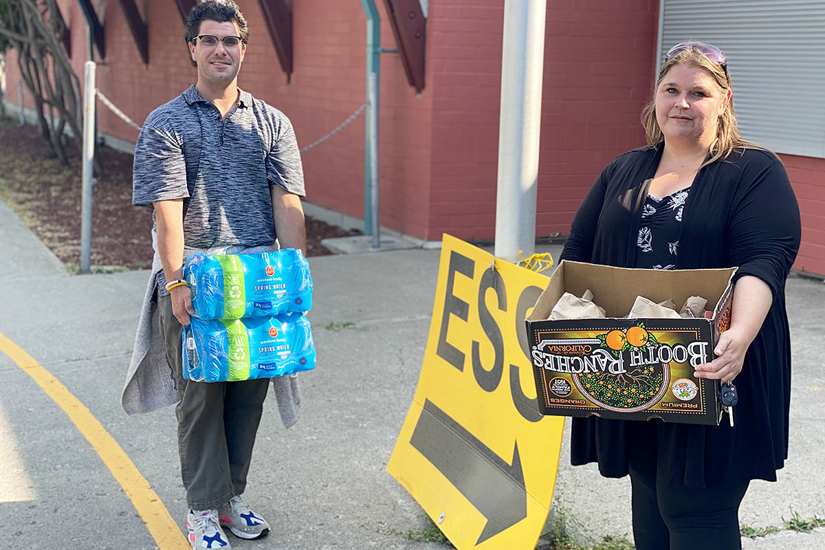Chris Cardamone and Jen Wiggins of the Southern Dakelh Nation Alliance deliver water and bagged lunches to the ESS centre in Williams Lake Wednesday afternoon (July 14). The food was for Ulkatcho First Nation evacuees who were flown out of their community west of Williams Lake.(Angie Mindus photo - Williams Lake Tribune)