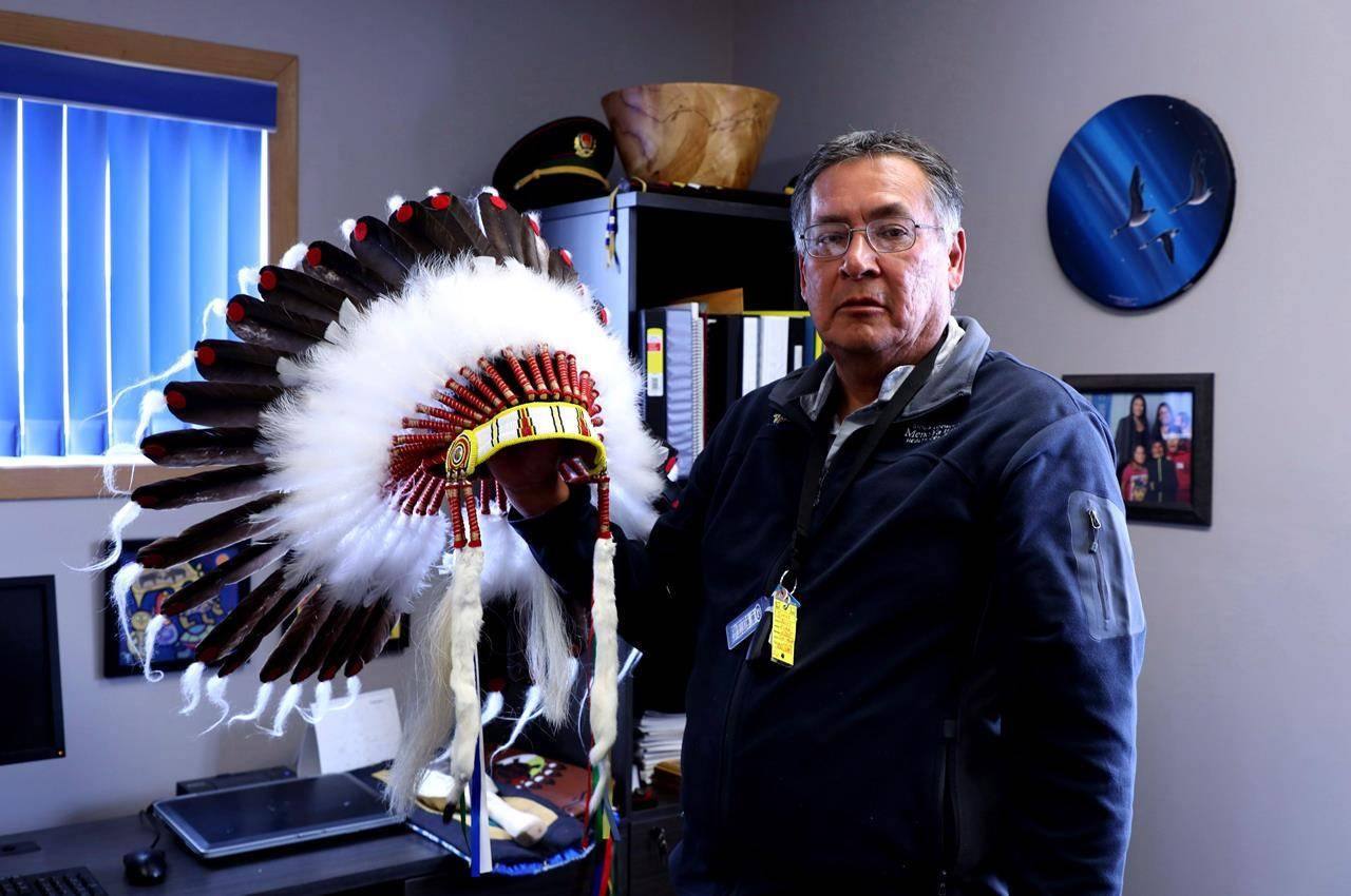 Chief Clifford Bull of the Lac Seul First Nation shows his ceremonial headdress in his office in Frenchman’s Head, Ont., Tuesday, April 24, 2018. THE CANADIAN PRESS/Colin Perkel