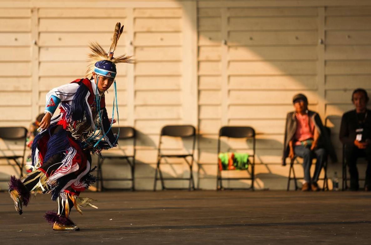 An Indigenous dancer performs in the Elbow River Camp at the Calgary Stampede in Calgary, Alta., Wednesday, July 14, 2021. THE CANADIAN PRESS/Jeff McIntosh