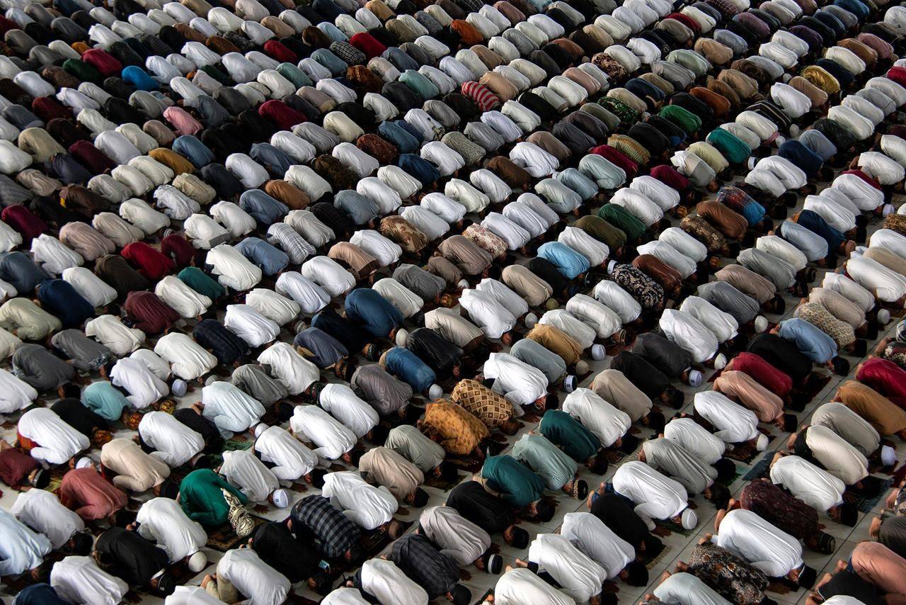 Muslims pray inside a mosque during an Eid al-Adha prayer in Lhokseumawe, Aceh province, Indonesia, Tuesday, July 20, 2021. Muslims across Indonesia marked a grim Eid al-Adha festival for a second year Tuesday as the country struggles to cope with a devastating new wave of coronavirus cases and the government has banned large gatherings and toughened travel restrictions. (AP Photo/Zik Maulana)
