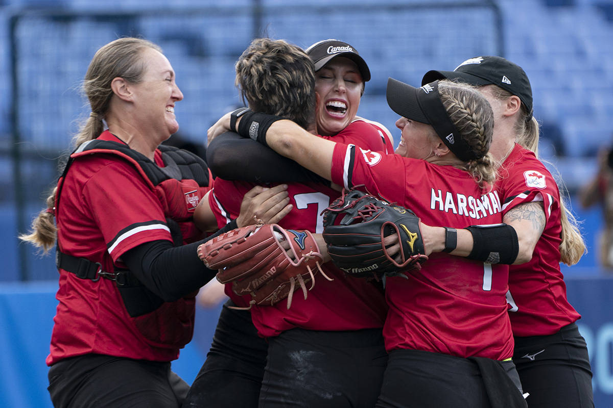Canada’s women’s softball team players Kaleigh Rafter (left to right), Jenn Salling, Danielle Lawrie, Kelsey Harshman and Emma Entzminger celebrate their win over Mexico in the bronze medal game at the Tokyo Olympics in Yokohama, Japan. (THE CANADIAN PRESS/Adrian Wyld)