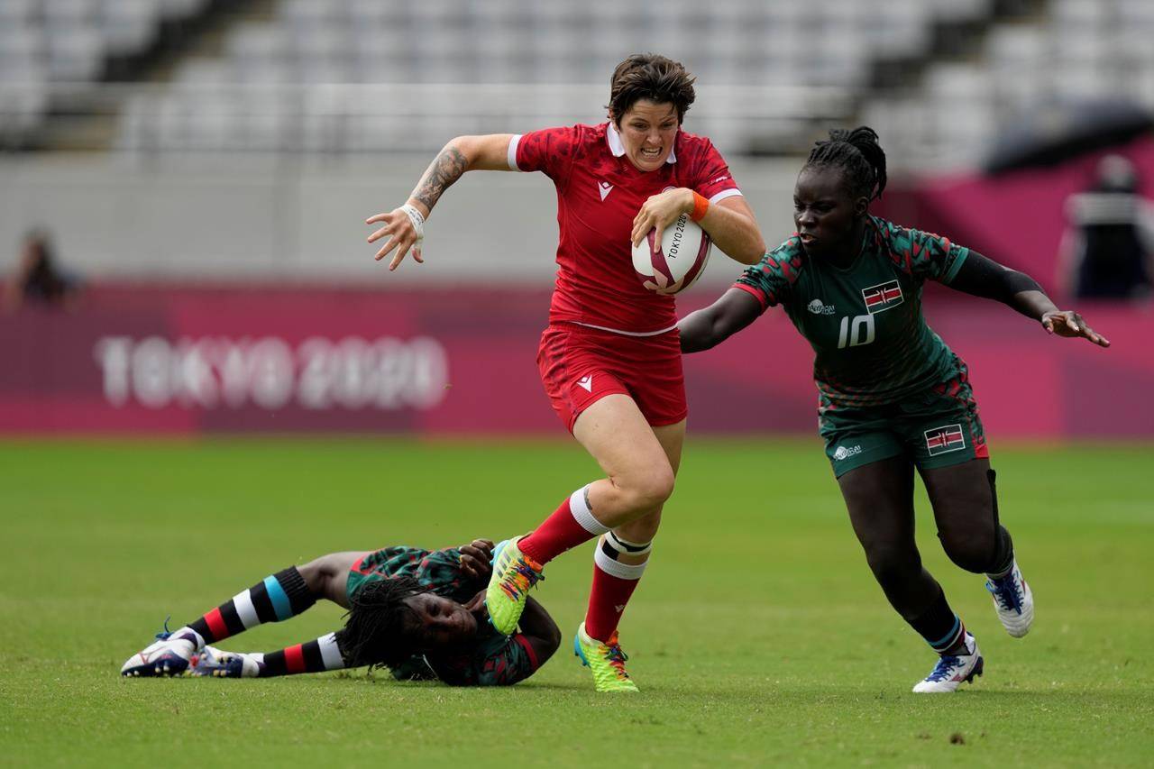 Canada’s Britt Benn, center, is chased by Kenya’s Grace Okulu, right, while evading a tackle by Kenya’s Sinaida Omondi, in their women’s rugby sevens 9-10 placing match at the 2020 Summer Olympics, Saturday, July 31, 2021 in Tokyo, Japan. THE CANADIAN PRESS/AP, Shuji Kajiyama
