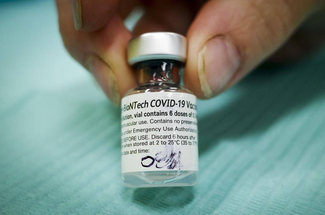 A vial of Pfizer-BioNTech COVID-19 vaccine is pictured at an Alberta Health Services vaccination clinic in Didsbury, Alta., Tuesday, June 29, 2021. The federal government is expecting to receive more than 2.3 million doses of Pfizer-BioNTech COVID-19 vaccines this week, as a fourth wave of COVID-19 infections looms driven by the spread of the highly-contagious Delta variant. THE CANADIAN PRESS/Jeff McIntosh