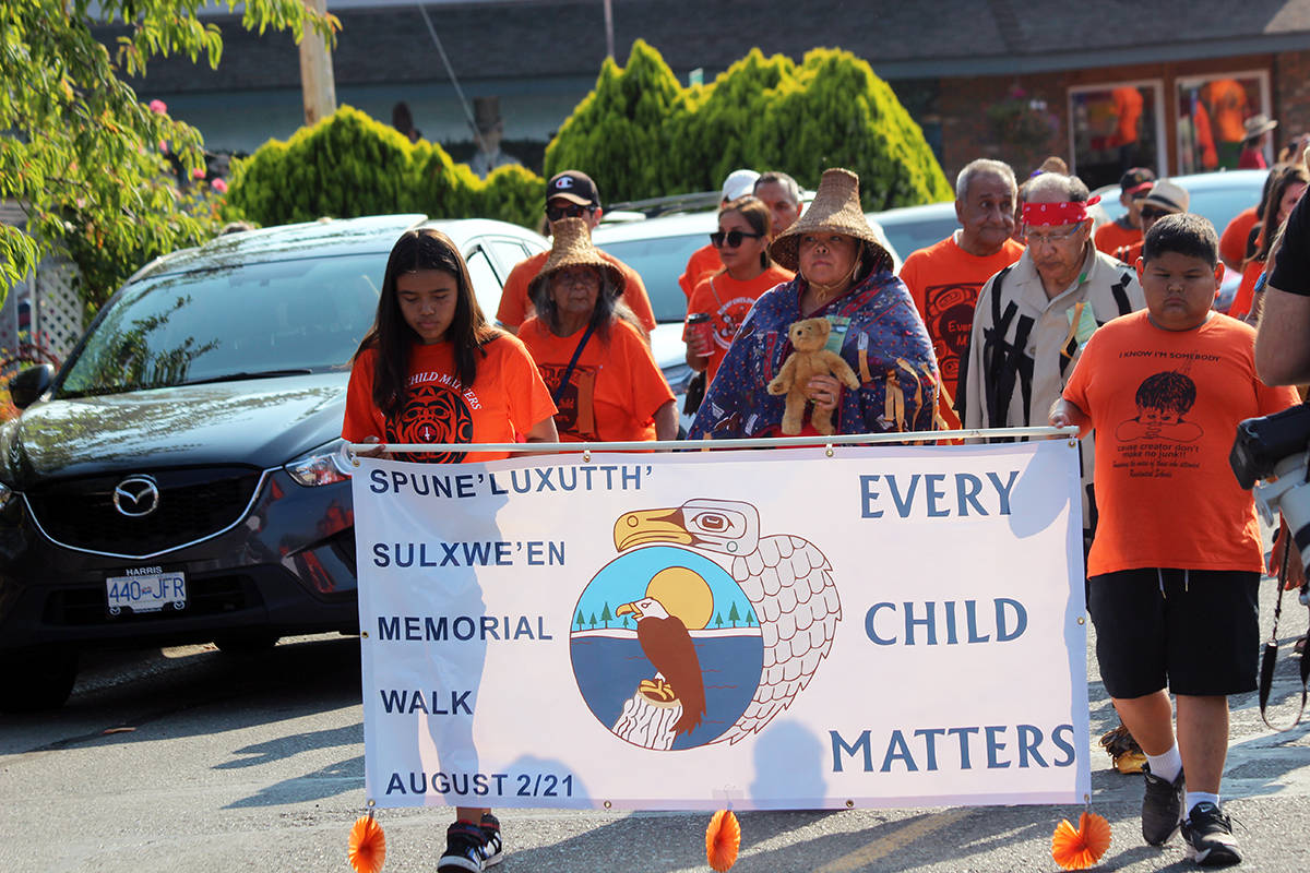 Today’s children lead the walk in honour of yesterday’s. (Photo by Don Bodger)