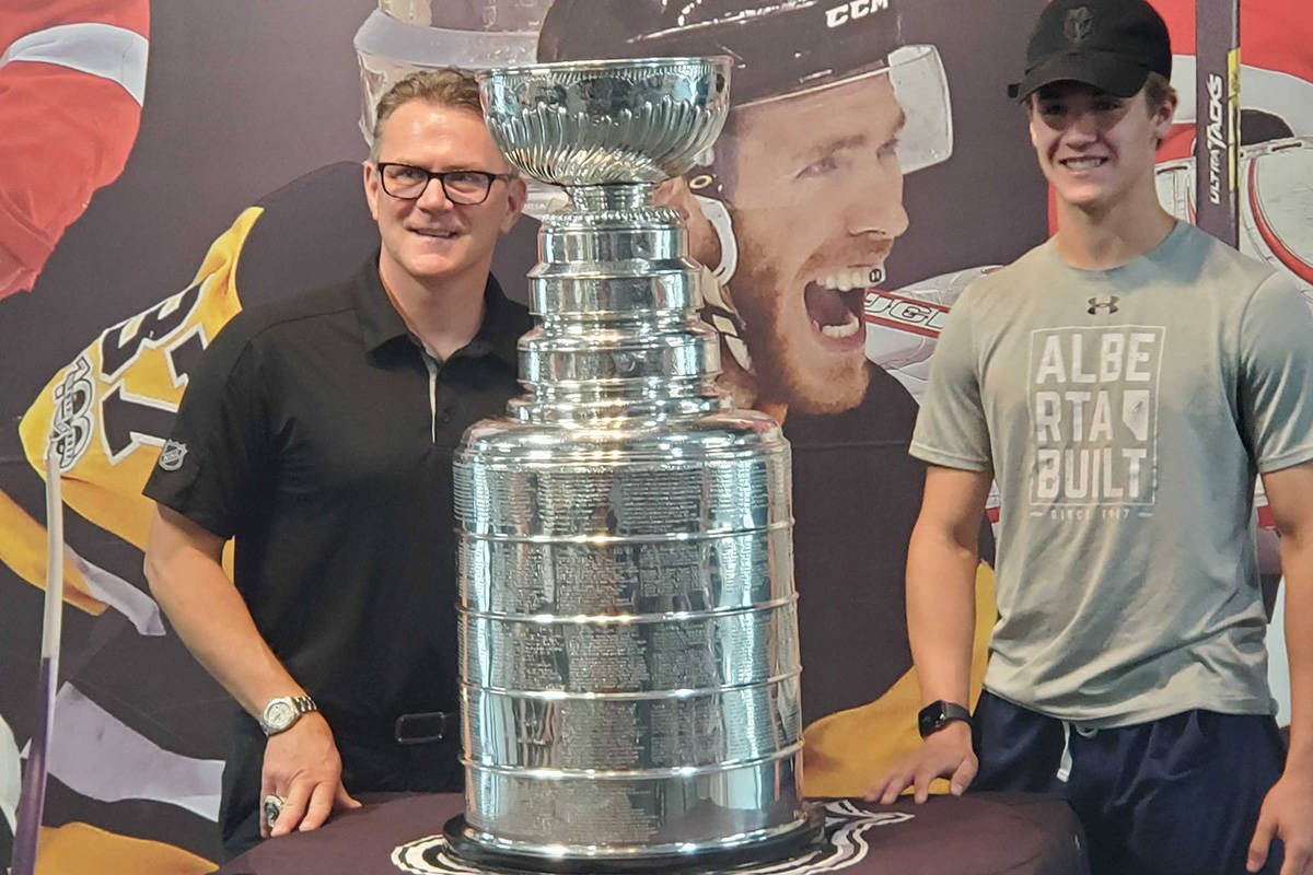 Coldstream’s Stacy Roest (left) enjoys a special moment with nephew Erick Roest of Lethbridge and the Stanley Cup Wednesday, Aug. 3, at Vernon’s Training House in Kal Tire Place North. Roest hosted a private function at the facility with the Cup, which he gets to spend a full day with as the assistant general manager of the back-to-back NHL champion Tampa Bay Lightning. (Roger Knox - Morning Star)