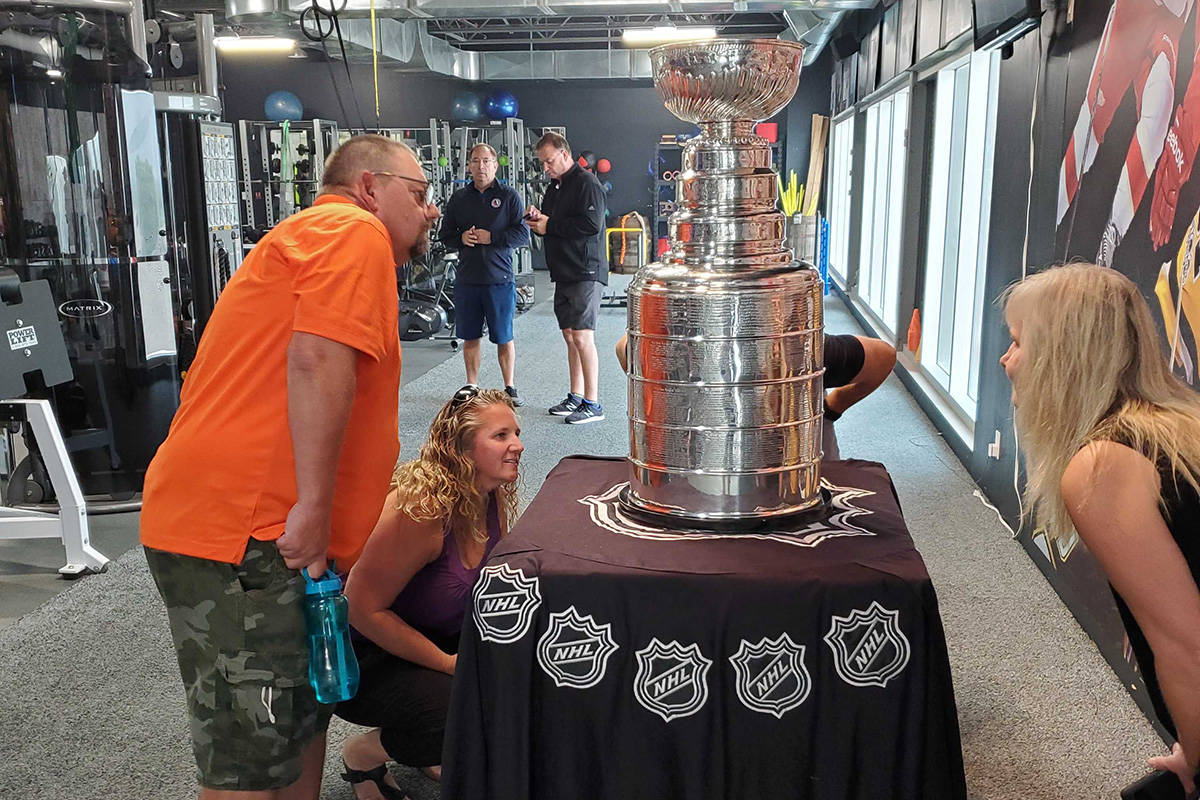 Cole Young (from left), Tara Young and Michelle McCrea enjoy a moment with the Stanley Cup at Training House in Vernon’s Kal Tire Place North arena Wednesday, Aug. 3. The Cup was in the building courtesy of Training House supporter Stacy Roest of Coldstream, the assistant general manager of the NHL champion Tampa Bay Lightning. Roest gets a day with the Cup and hosted a private function at the facility Wednesday morning. (Roger Knox - Morning Star)