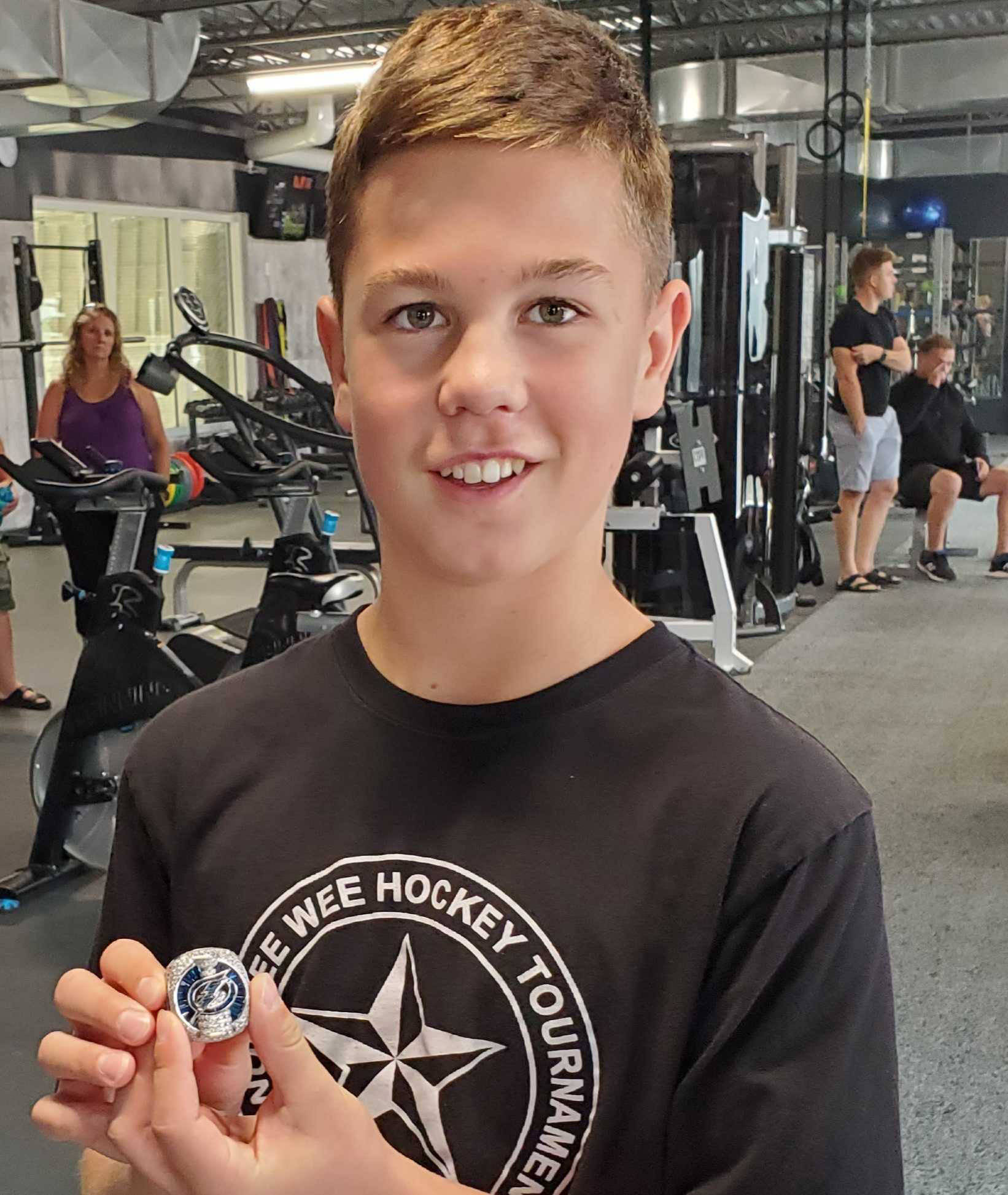Noah Frick of Coldstream, 13, admires the 2020 Stanley Cup championship ring belonging to Coldstream’s Stacy Roest of the Tampa Bay Lightning at Vernon’s Training House in Kal Tire Place North arena Wednesday, Aug. 3. Roest, his ring and the Stanley Cup were on hand for a private function at the facility, Roest’s way of saying thanks to owners Rhonda Catt and Carla Rayner and Training House clients for their encouragement and support. Roest is the Lightning’s assistant general manager and gets a full day with Cup. (Roger Knox - Morning Star)