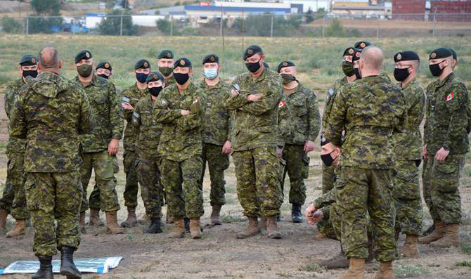 Newly arrived members of 1 Combat Engineer Regiment (CER) at Land Task Force – Vernon, receive an in-brief from the Camp Sergeant Major. 1 CER is deploying as part of Operation LENTUS in assistance to BC Wildfire Service. (Captain Jamie Blois, Public Affairs Officer, Land Task Force – Vernon photo)