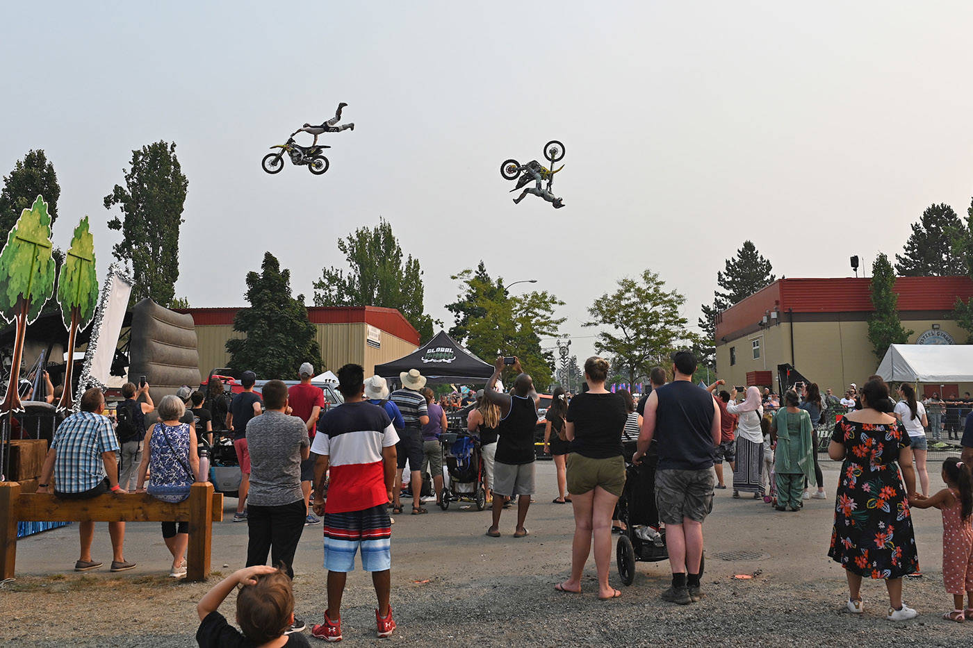 Motocross riders with Global FMX from Kelowna, B.C. do mid-air stunts during the Abbotsford Agrifair on Sunday, Aug. 1, 2021. (Jenna Hauck/ Black Press)