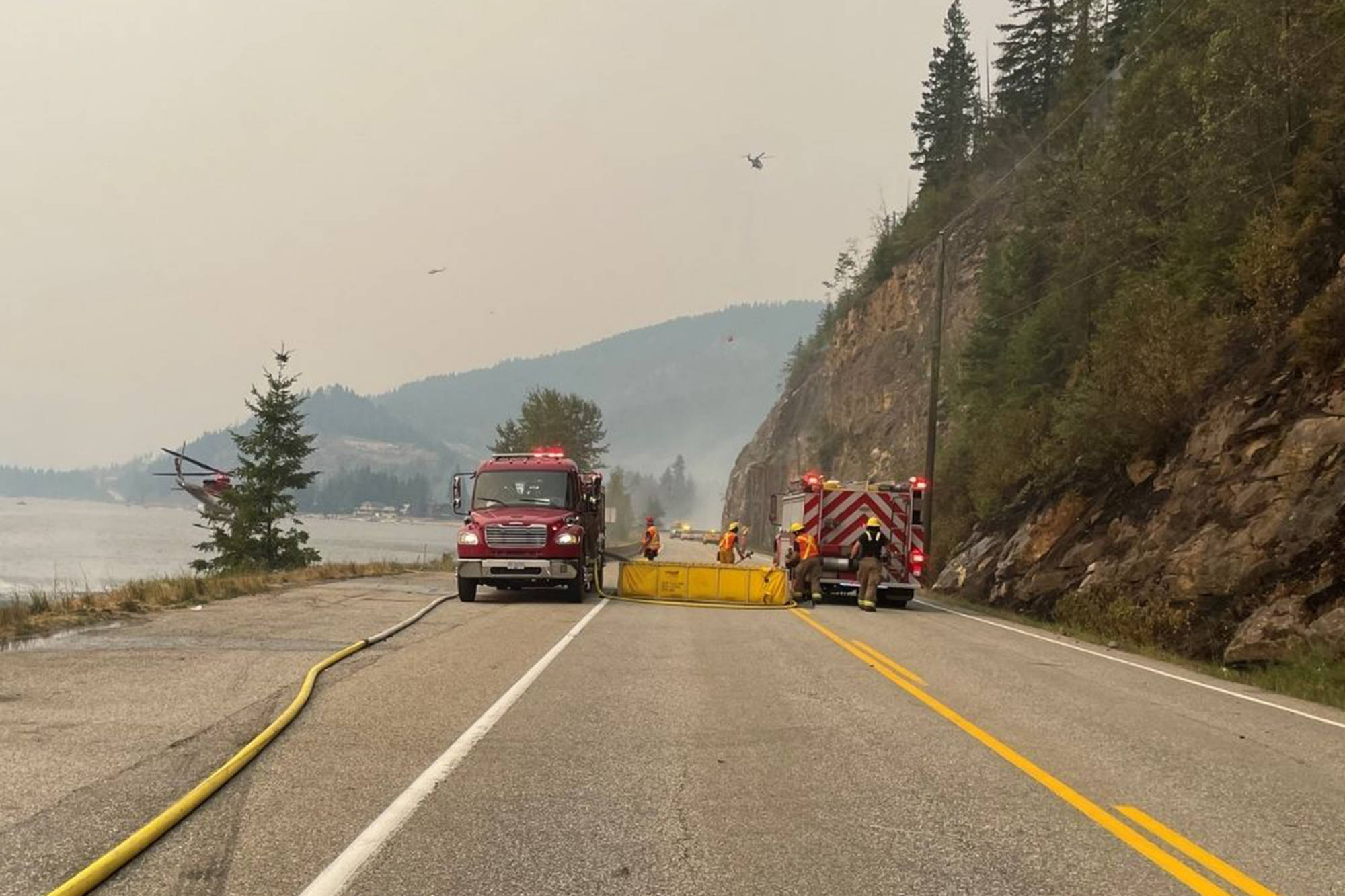 Firefighters block off a section of Highway 97A during earlier firefighting efforts on the Two Mile Road wildfire near Sicamous. (CSRD photo)