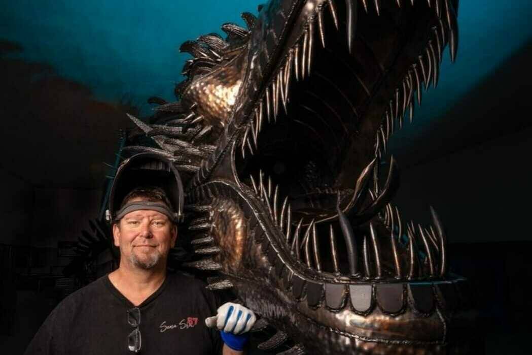 Kevin Stone posing with one of his sculptures (Kevin Stone metal sculptor/Facebook)