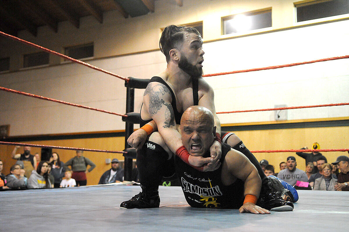 Rob the Giant (4’11”) gets a hold on Short Sleeve Sampson during a Midget Wrestling Warriors event at Tzeachten Hall in Chilliwack on March 22, 2019. Tuesday, Oct. 5 is Kiss a Wrestler Day. (Jenna Hauck/ Chilliwack Progress file)