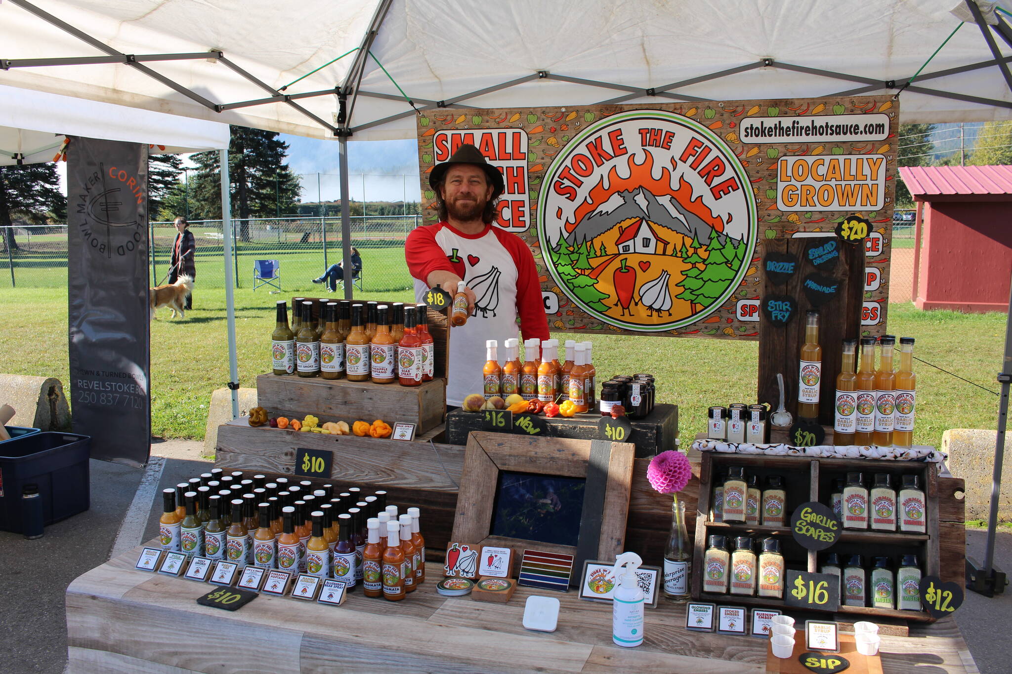 Stu Smith at the Stoke the Fire table at the Revelstoke farmers market. (Josh Piercey/Revelstoke Review)