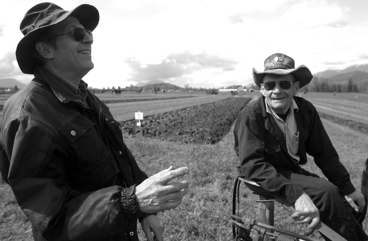 François Freyvogel (left) shares a laugh with Ted Giesbrecht during the Chilliwack Plowing Match on April 9, 2005. Tuesday, Oct. 12, 2021 is Old Farmers’ Day. (Jenna Hauck/ Chilliwack Progress file)