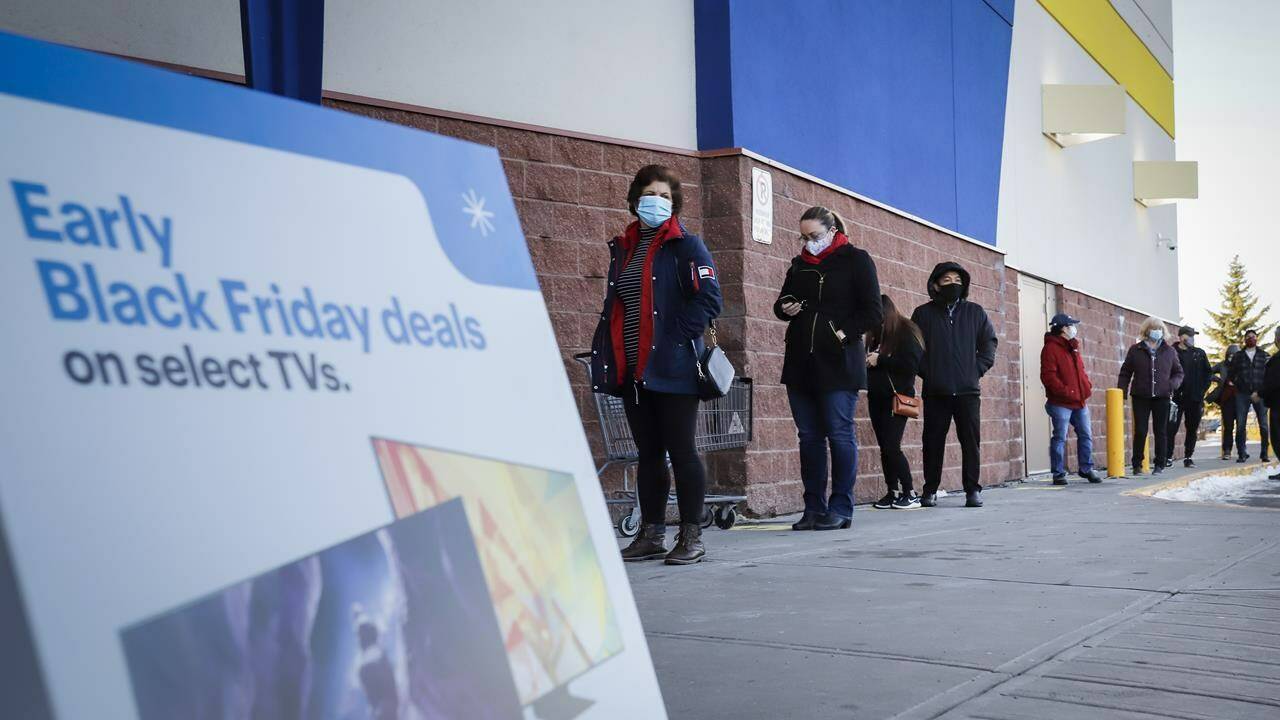Shoppers wait in line at an electronics store in Calgary, Alta., Friday, Nov. 27, 2020, amid a worldwide COVID-19 pandemic. THE CANADIAN PRESS/Jeff McIntosh