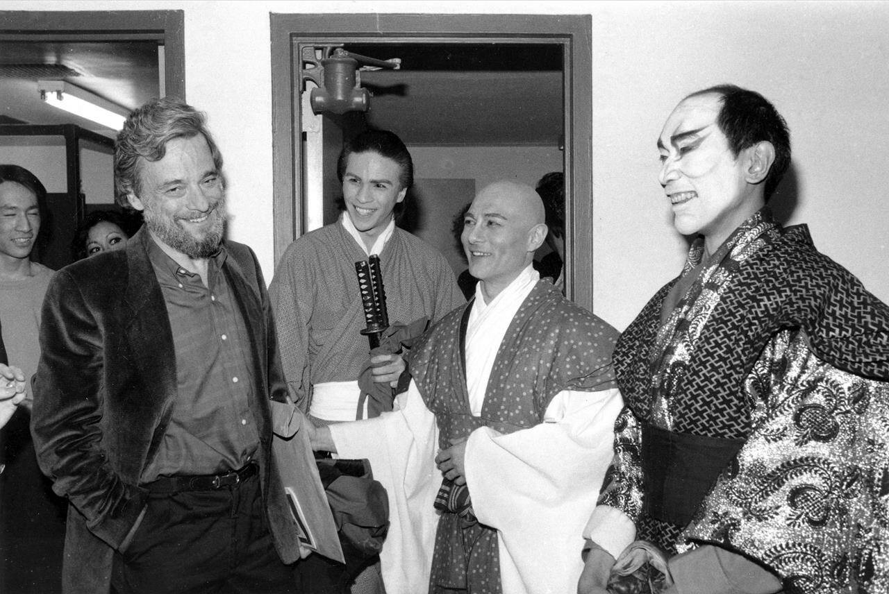 FILE - Composer-lyricist Stephen Sondheim, left, is shown with cast members of “Pacific Overtures” after the closing performance of the revival musical at New York’s Church of the Heavenly Rest at York Theater, Sunday, April 14, 1984. The actors are, from left, Kevin Gray, Ernest Ababa, and Tony Marino. Sondheim, the songwriter who reshaped the American musical theater in the second half of the 20th century, has died at age 91. Sondheim’s death was announced by his Texas-based attorney, Rick Pappas, who told The New York Times the composer died Friday, Nov. 26, 2021, at his home in Roxbury, Conn. (AP Photo, File)