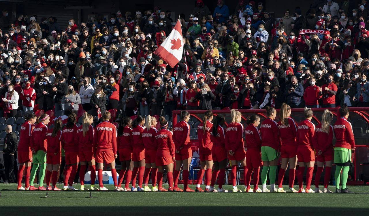 A fan holds a Canadian flag in the stands as players are introduced at the start of a match against New Zealand, in Ottawa, Saturday, Oct. 23, 2021. Canada Soccer said it has agreed to a “transparent, independent review of the investigation of allegations” against former women’s coach Bob Birarda during the time when he was employed by the association. THE CANADIAN PRESS/Adrian Wyld
A fan holds a Canadian flag in the stands as players are introduced at the start of a match against New Zealand, in Ottawa, Saturday, Oct. 23, 2021. Canada Soccer said it has agreed to a “transparent, independent review of the investigation of allegations” against former women’s coach Bob Birarda during the time when he was employed by the association. THE CANADIAN PRESS/Adrian Wyld
