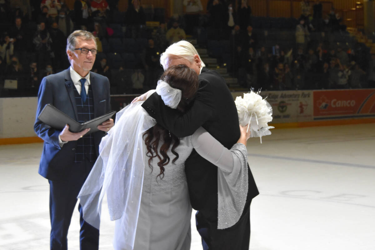 Radka and Jim Peck embrace in holy matrimony for a different kind of ‘face-off’ at centre ice. (Cole Schisler photo)