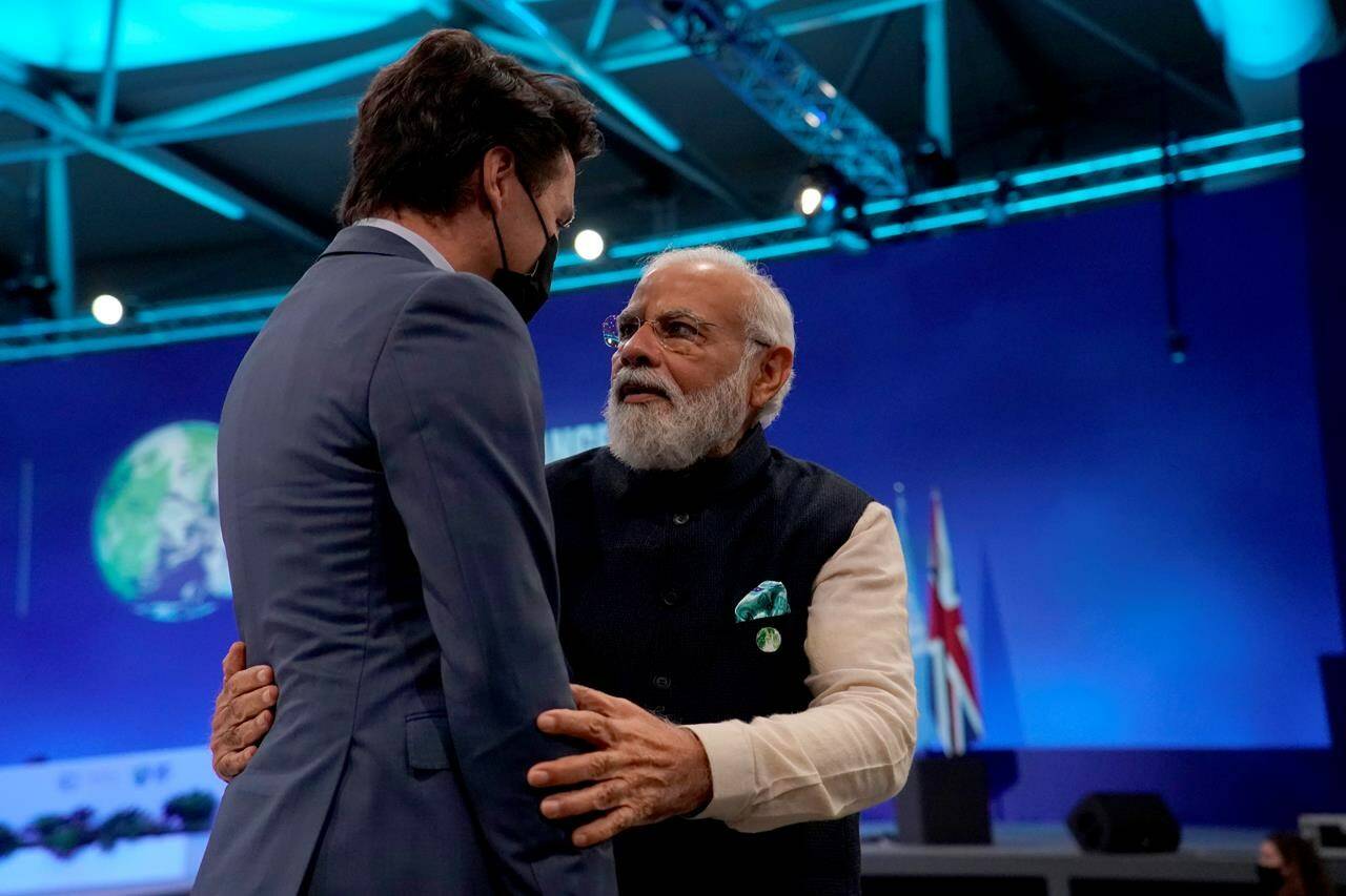 India Prime Minister Narendra Modi, right, embraces Canada’s Prime Minister Justin Trudeau as they attend the opening ceremony of the COP26 U.N. Climate Summit, in Glasgow, Scotland, Monday, Nov. 1, 2021. Canada and India are quietly setting the stage to reboot formal free trade talks as the Trudeau government seeks economic alternatives to China following the dispute over the two Michaels affair. THE CANADIAN PRESS/AP-Alberto Pezzali