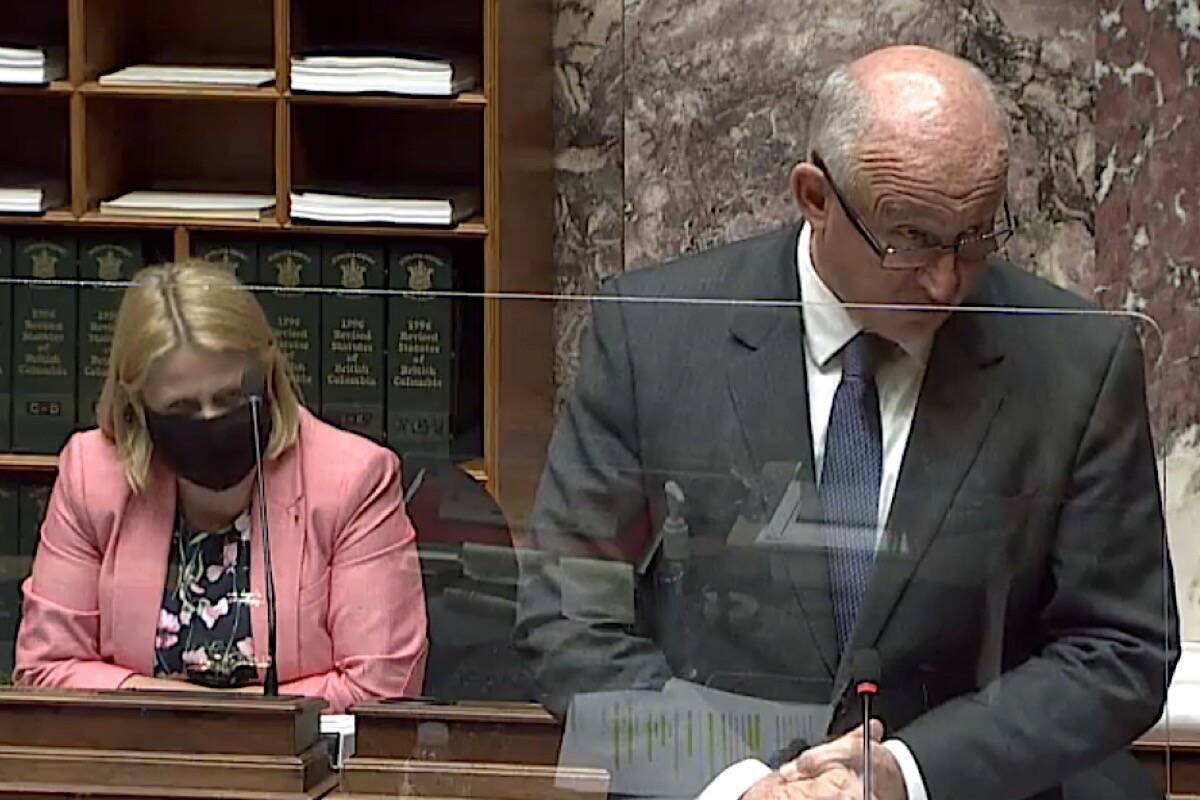 B.C. NDP house leader Mike Farnworth takes a question in the B.C. legislature as Citizens’ Services Minister Lisa Beare listens, June 16, 2021. (Hansard TV)