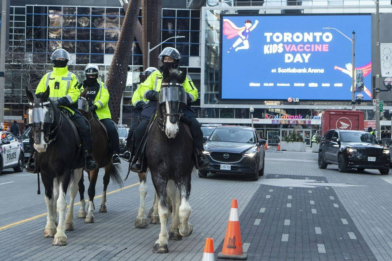 Police patrol outside a children’s COVID-19 vaccine clinic at the Scotiabank Arena, in Toronto, as anti-vaccine protesters gather, on Dec.12, 2021.THE CANADIAN PRESS/Chris Young