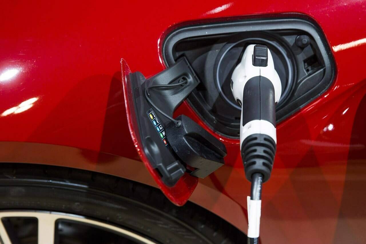 An electric plug is connected to a BMW i8 vehicle during the Canadian International Auto Show in Toronto, Thursday February 16, 2017. Transport Minister Omar Alghabra says the government is looking to overhaul the rebate program for electric vehicles to more closely align with the kinds of cars Canadians actually want to buy. THE CANADIAN PRESS/Mark Blinch