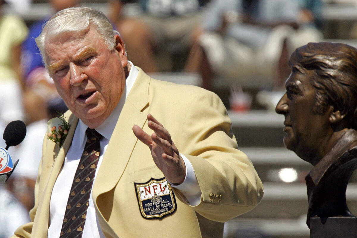 FILE - In this Aug. 5, 2006, file photo, former Oakland Raiders coach John Madden gestures toward a bust of himself during his enshrinement into the Pro Football Hall of Fame in Canton, Ohio. After a decade run as a successful coach of the Raiders, Madden made his biggest impact on the game after moving to the broadcast booth at CBS in 1979. He became the network’s lead analyst two years later and provided the sound track for NFL games for most of the next three decades, entertaining millions with his interjections of “Boom!” and “Doink!” throughout games, while educating them with his use of the telestrator and ability to describe what was happening in the trenches. (AP Photo/Mark Duncan, File)