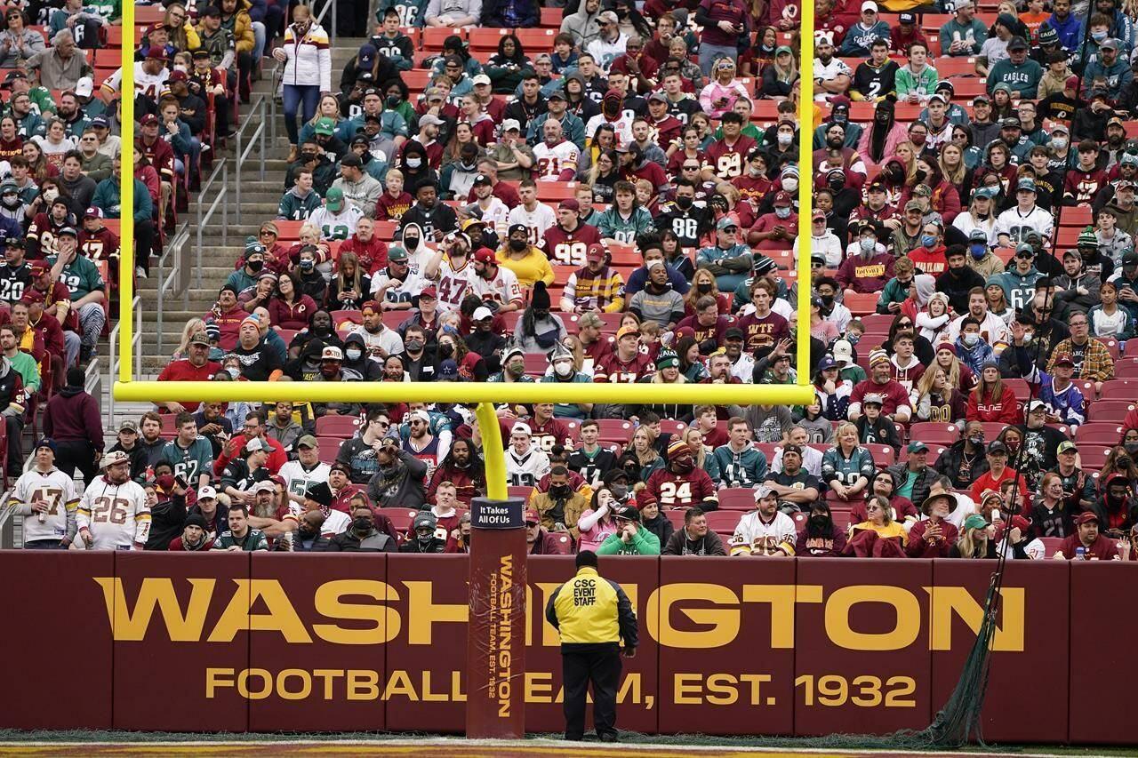 Fans sitting in a section behind the field goals during an NFL football game between Philadelphia Eagles and Washington Football Team, Sunday, Jan. 2, 2022, in Landover, Md. (AP Photo/Alex Brandon)