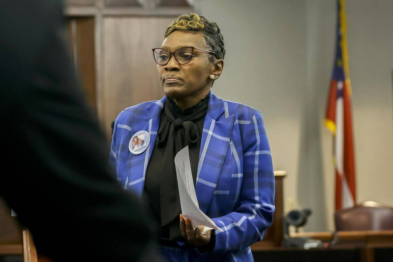 Ahmaud Arbery’s mother, Wanda Cooper-Jones leaves the podium after giving her impact statement to Superior Court Judge Timothy Walmsley during the sentencing of Greg McMichael and his son, Travis McMichael, and a neighbor, William “Roddie” Bryan in the Glynn County Courthouse, Friday, Jan. 7, 2022, in Brunswick, Ga. The three found guilty in the February 2020 slaying of 25-year-old Ahmaud Arbery. (AP Photo/Stephen B. Morton, Pool)