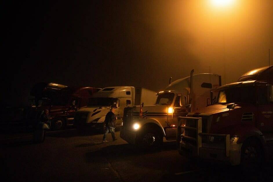 Trucks sit idle before a cross-country convoy departure for Ottawa to protest a federal vaccine mandate for truckers, in Delta, B.C., on Sunday, January 23, 2022. THE CANADIAN PRESS/Darryl Dyck