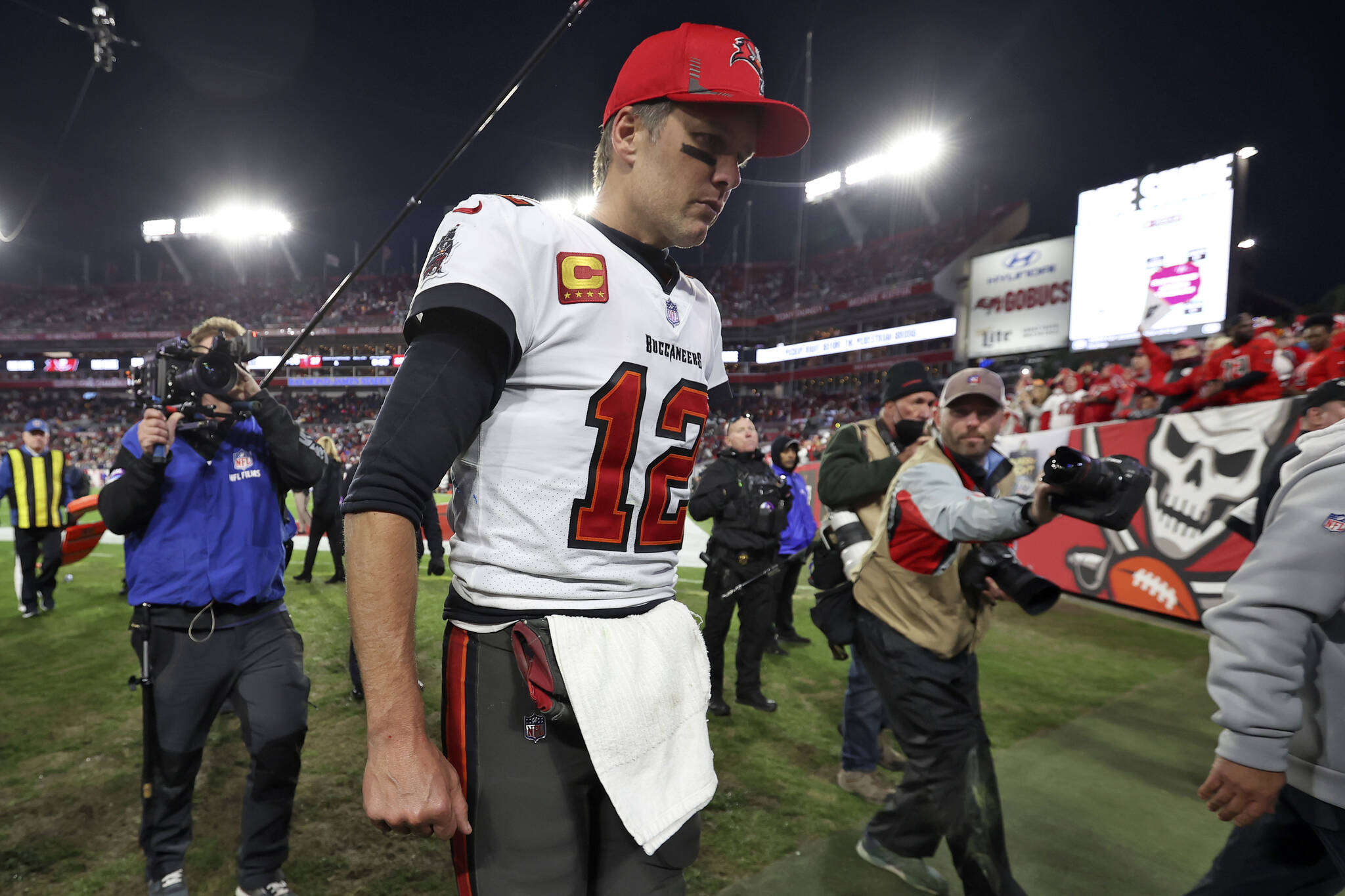 FILE - Tampa Bay Buccaneers quarterback Tom Brady (12) reacts as he leaves the field after the team lost to the Los Angeles Rams during an NFL divisional round playoff football game Sunday, Jan. 23, 2022, in Tampa, Fla. (AP Photo/Mark LoMoglio, File)