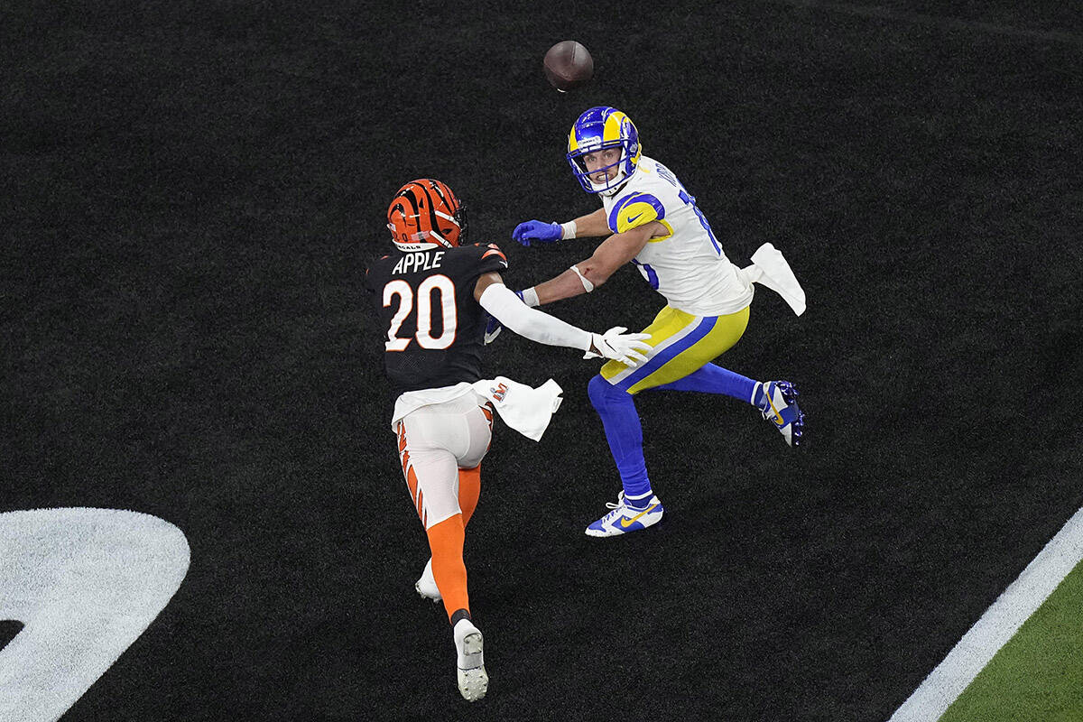 Los Angeles Rams wide receiver Cooper Kupp (10) eyes a pass in the end zone as Cincinnati Bengals cornerback Eli Apple (20) attempts to tackle during the second half of the NFL Super Bowl 56 football game, Sunday, Feb. 13, 2022, in Inglewood, Calif. (AP Photo/Matt Rourke)