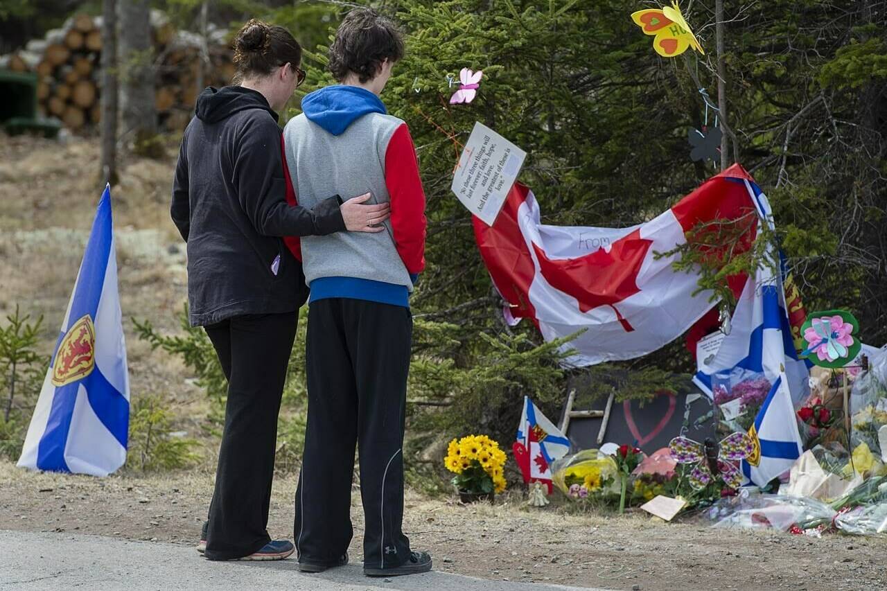 Visitors to a roadside memorial pay their respects in Portapique, N.S. on Friday, April 24, 2020. A public inquiry into the worst mass shooting in modern Canadian history is set to begin hearings this week in Nova Scotia.THE CANADIAN PRESS/Andrew Vaughan